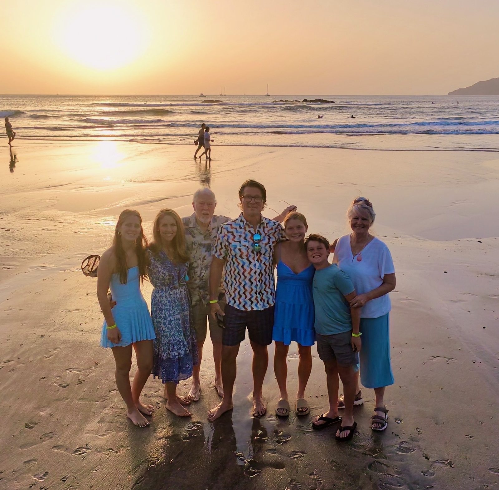 Family group on a beach at sunset