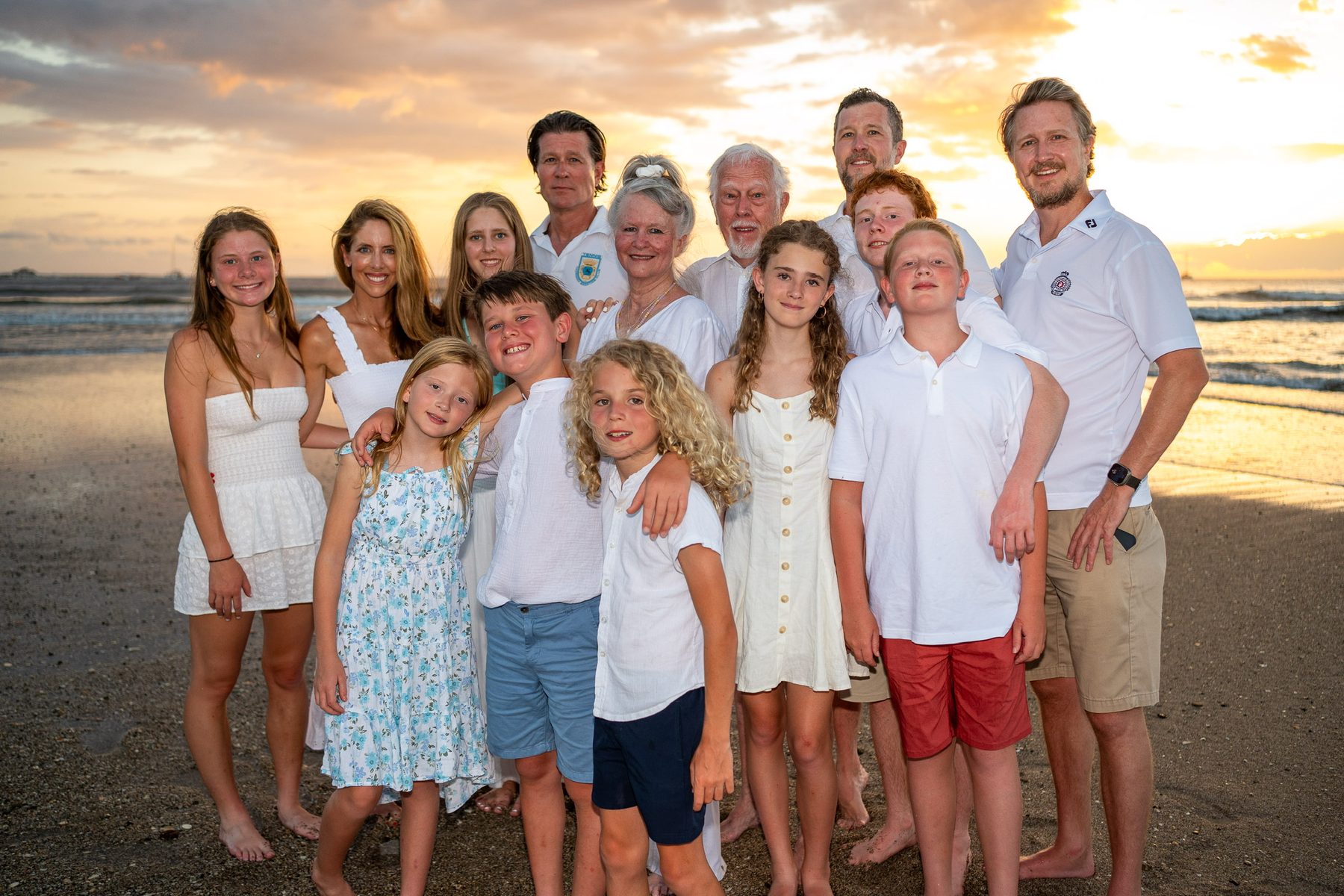 Extended family on a beach at sunset