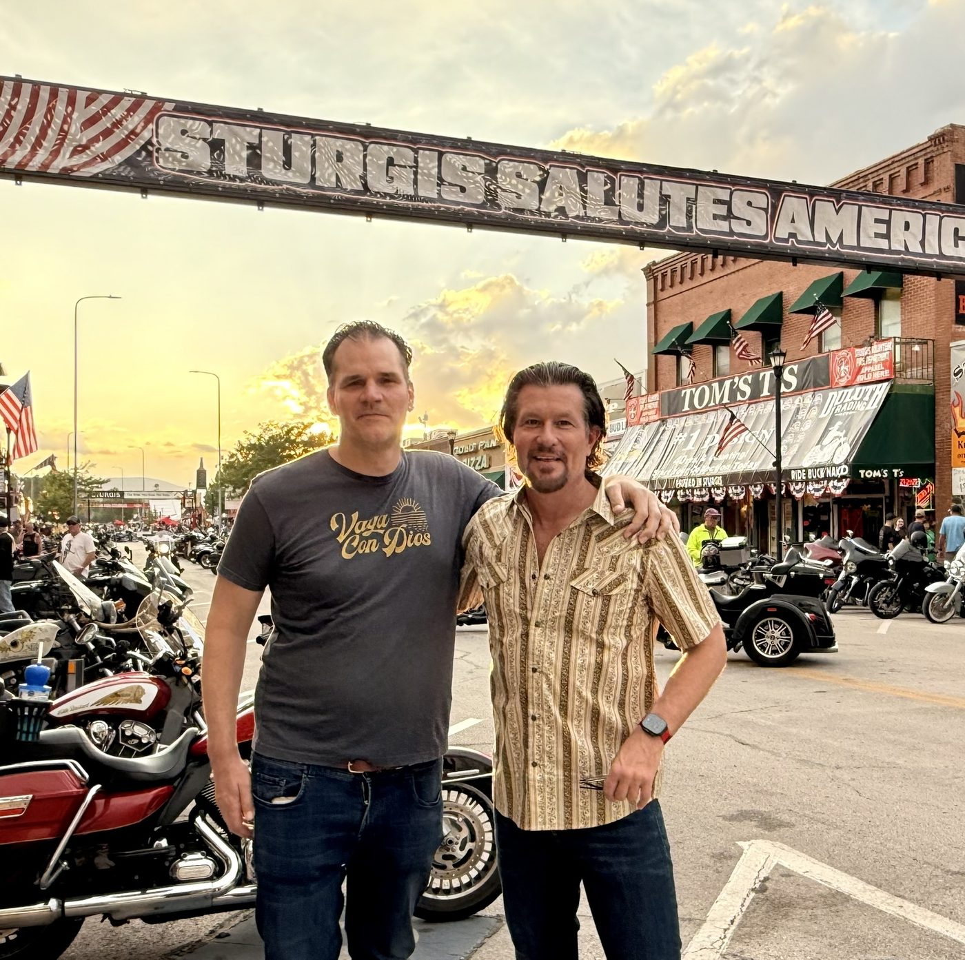 Justin and a friend under the Sturgis Salutes America banner